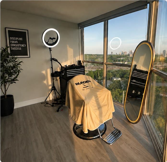 The Blades Studios penthouse chair, ring light and mirror against a floor-to-ceiling window over Mississauga